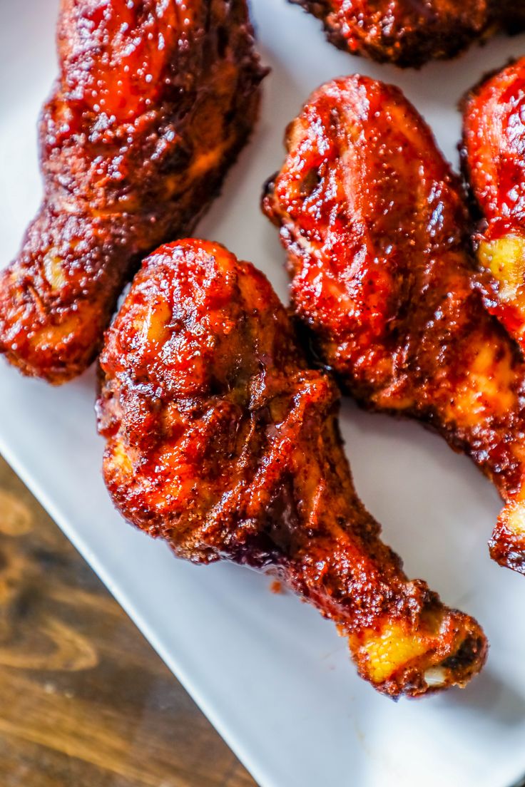 some chicken wings are sitting on a white plate