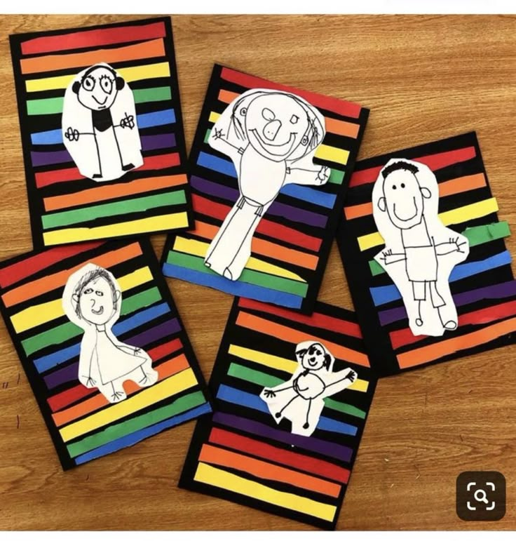 four colorful cards with pictures of people and animals in them on a wooden table top