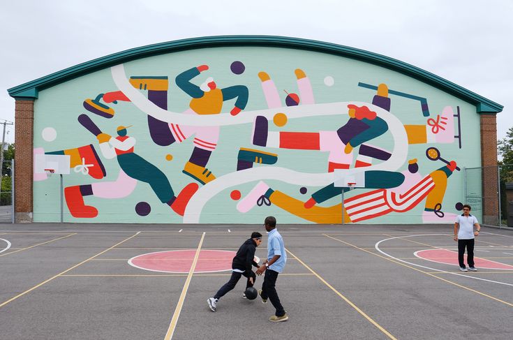 several people are playing basketball on an outdoor court with painted mural behind the hoopway