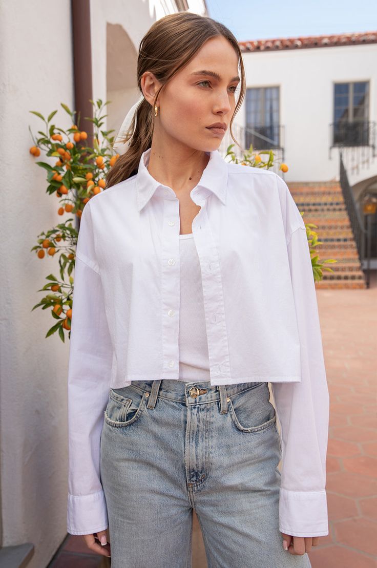 An oversized fit with classic shirting details in a true cropped length. Designed to wear with all your favorite high waisted denim, trousers & skirts. Shown here in our signature Poplin, this is the wardrobe essential we needed. Pair with the Slouchy High Waisted Trouser for a timelessly chic look. Made in the USA97% Cotton 3% SpandexModel is 5'9.5" and wearing a size 1