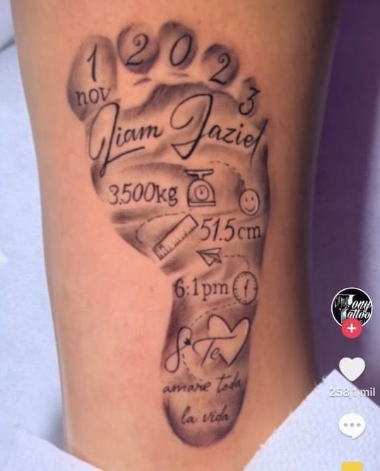 a tattoo on the leg of a person with a name and birth date written in it