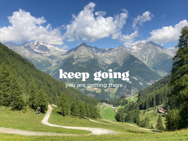 a scenic view of mountains and trees with the words keep going you are getting there