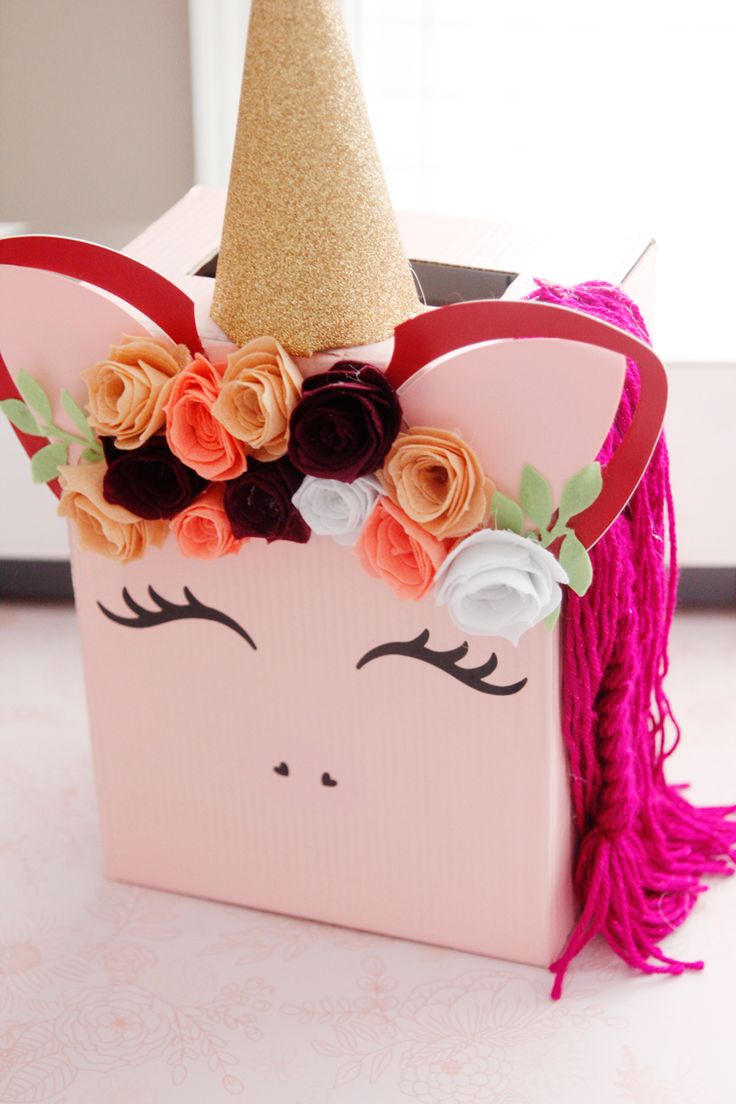 a pink box with flowers and a unicorn's head