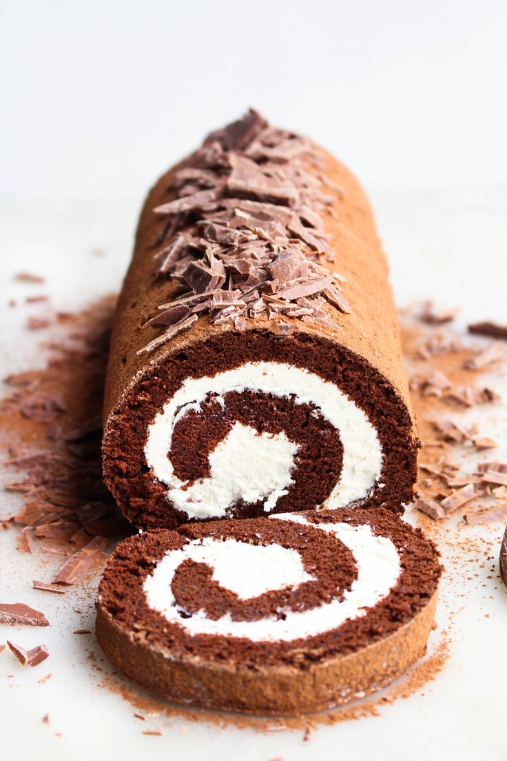 there is a chocolate roll with white frosting on it