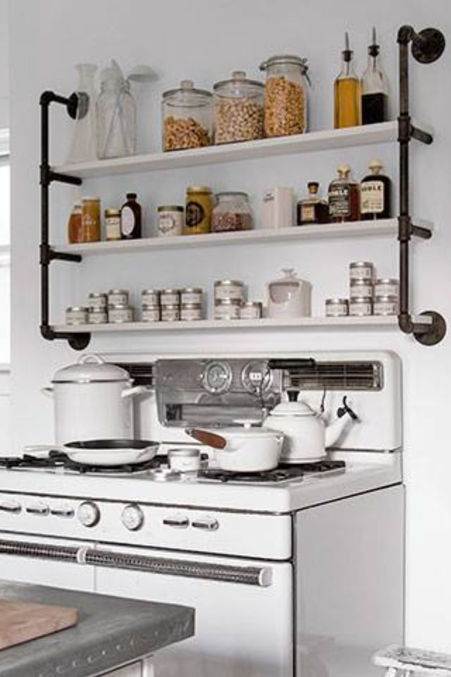 a white stove top oven sitting inside of a kitchen