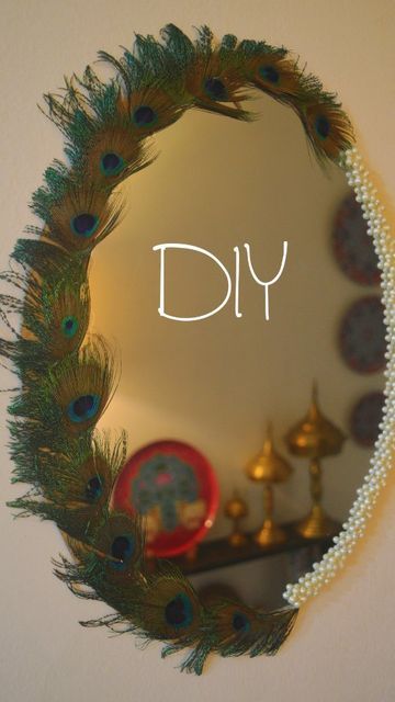 a mirror that has peacock feathers on it and the words diy written in white