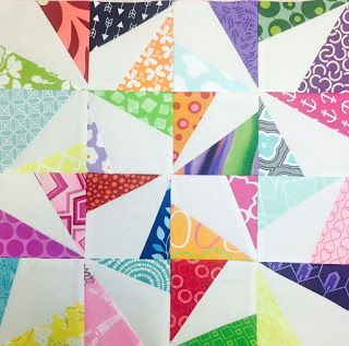 the colorful quilt is made up of many different colors and shapes, including one triangle