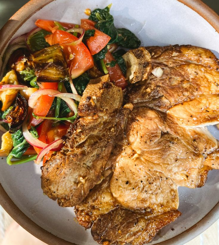 a white plate topped with meat and veggies