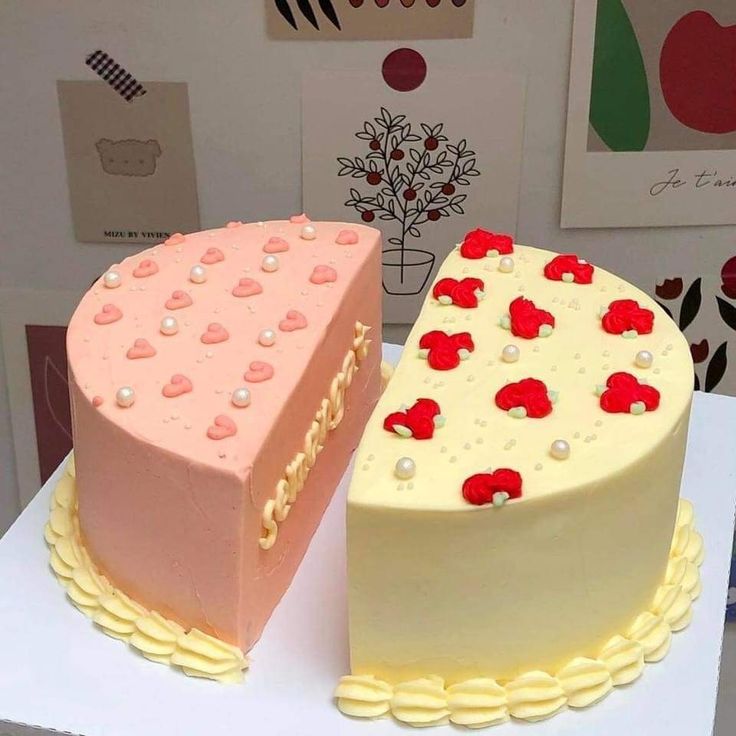 two cakes with hearts on them sitting on top of a table