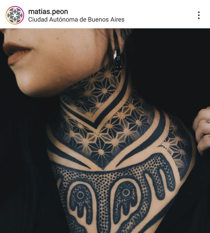 a woman with tattoos on her neck and chest