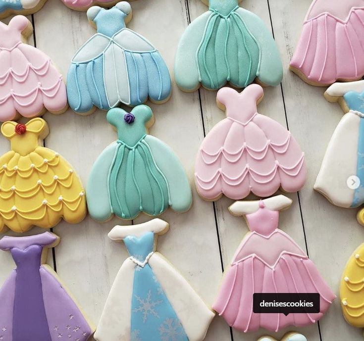 some decorated cookies with princess dresses on them