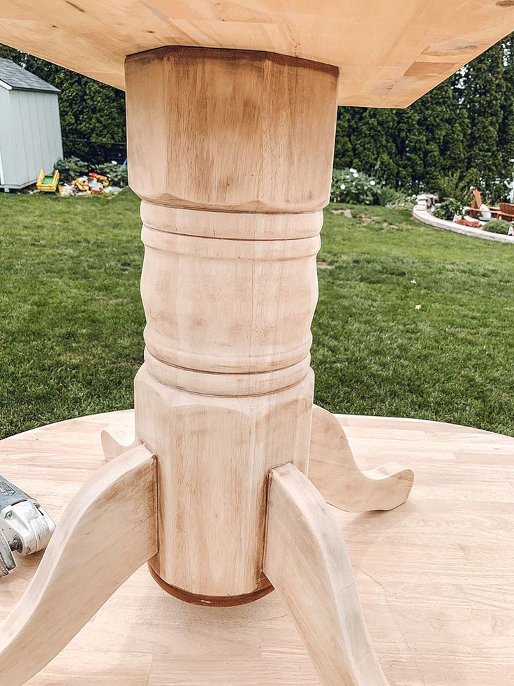 a close up of a wooden table in the middle of a field