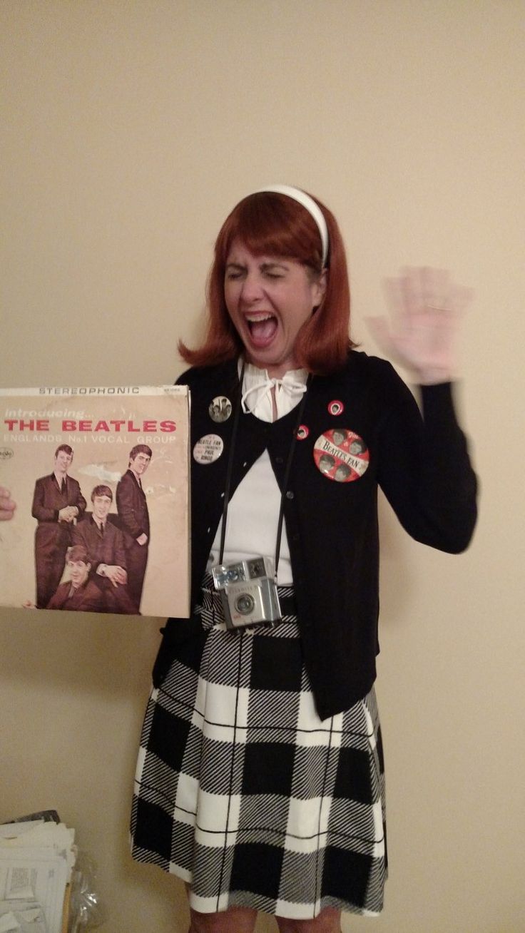 a woman in a skirt holding up a record