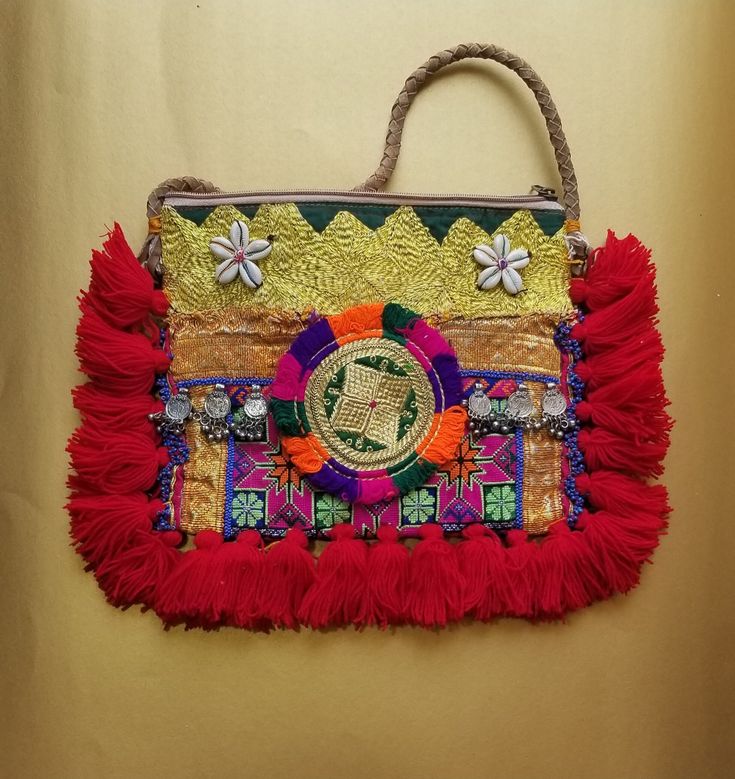 Our Adorned Outland collection features a large variety of exquisite handmade bags. These bags come from the beautiful country of India and each bag is uniquely handcrafted. The artisans spend hours and days weaving each bag. This pattern is called "Banjara".  As each bag's handcrafted, its design and pattern are unique and one of its kind. Owning this bag makes you feel proud as it's one and the only with its specific "Banjara" pattern and design. Bohemian Pouch Shoulder Bag With Hand-stitched Details, Artisan Hand-stitched Festival Bags, Traditional Hand-stitched Bags For Everyday, Traditional Woven Hobo Bag For Everyday Use, Traditional Red Handmade Potli Bag, Traditional Woven Shoulder Bag For Travel, Traditional Woven Shoulder Bag For Everyday Use, Traditional Handmade Bags For Festival, Handmade Multicolor Straw Bag For Festival