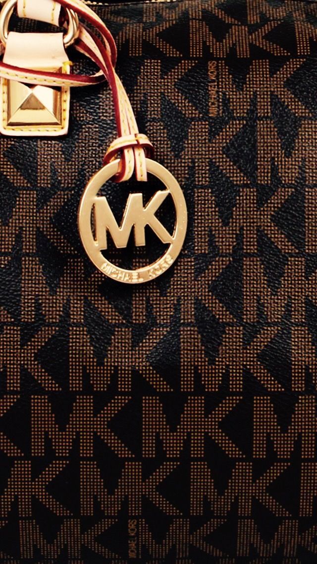 a brown and black handbag with a monogram logo on the front, featuring a key chain