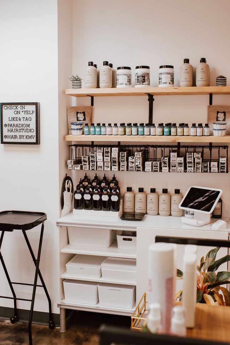 the inside of a beauty salon with lots of products on shelves