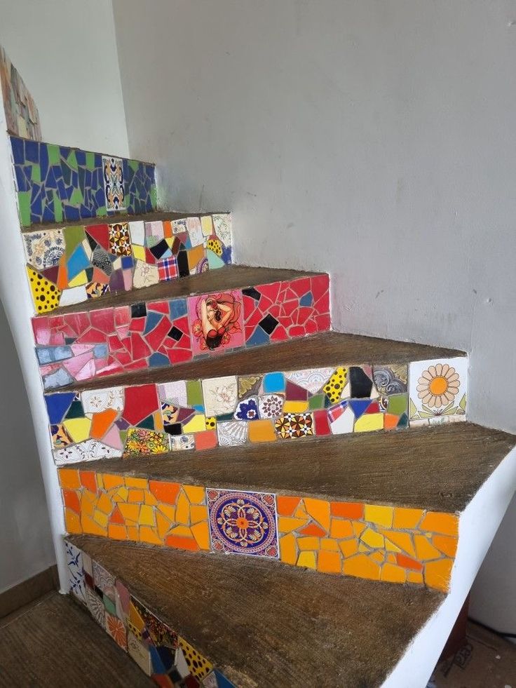 an artisticly designed stair case with colorful tiles on it