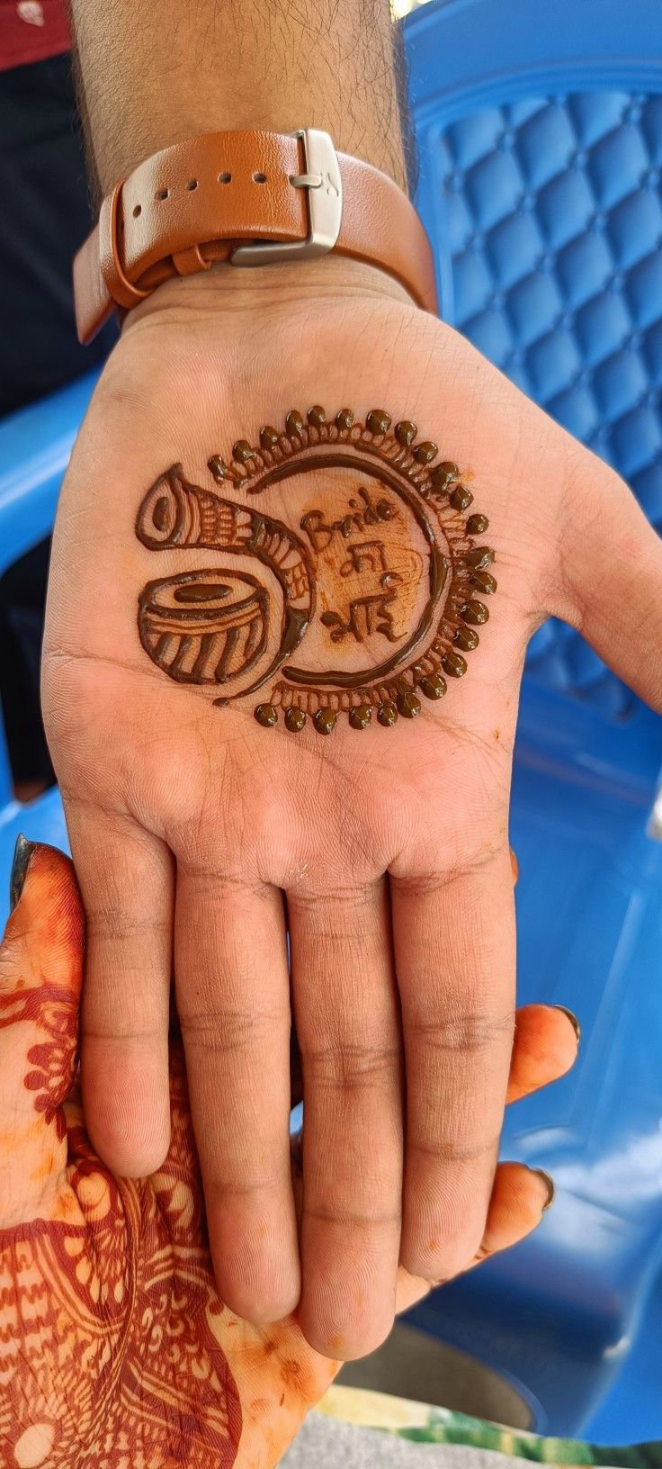 a person holding their hand with a henna on it