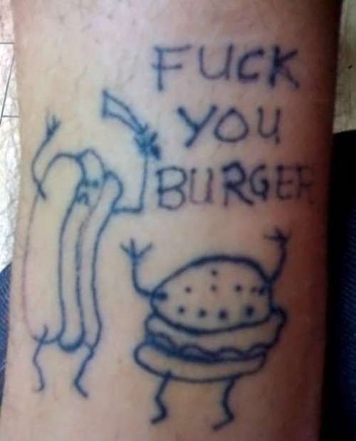 a tattoo on the leg of a person that has writing on it and an image of a burger