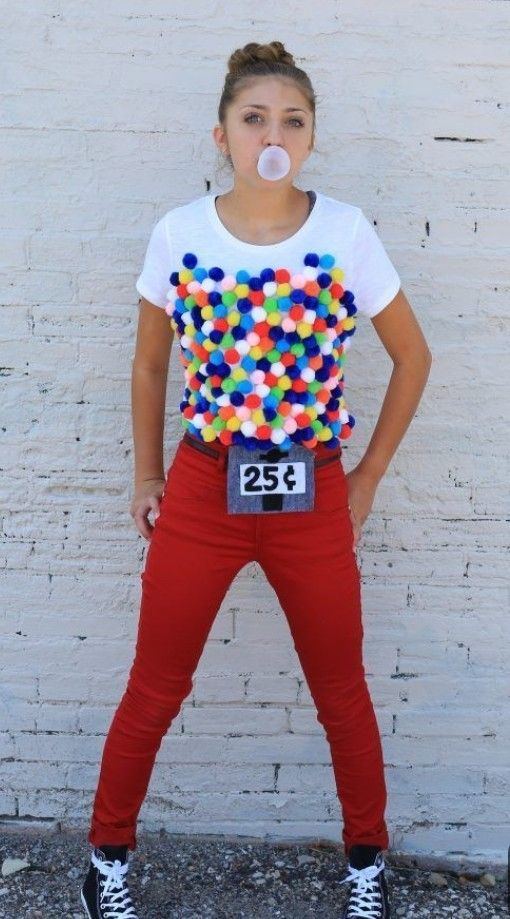 a woman wearing red pants and a white t - shirt with colorful balls on it