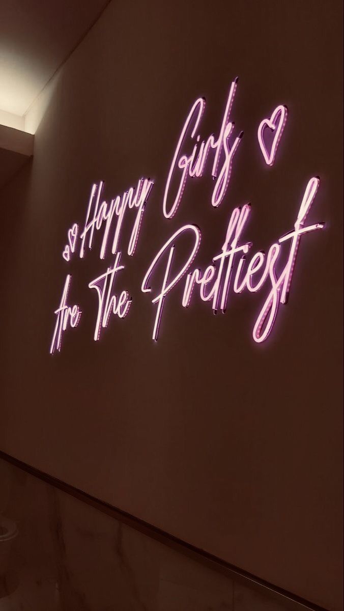 a neon sign that says happy girls and she's the prettiest in pink