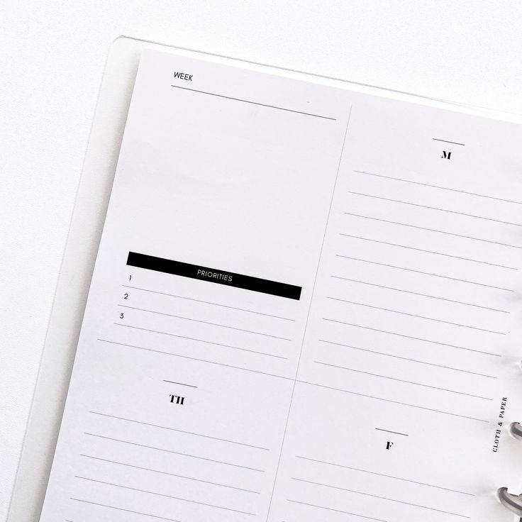 an open planner sitting on top of a white table