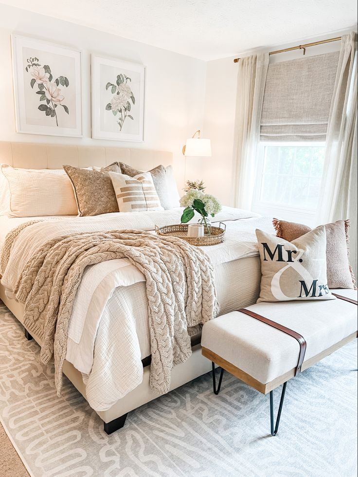 a bedroom with white bedding and pillows