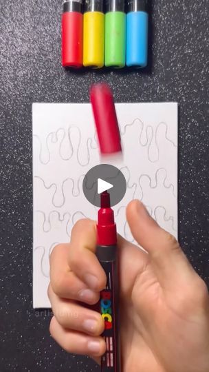 someone holding a crayon marker in front of some colored crayons on a piece of paper