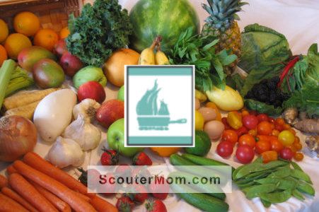 an assortment of fruits and vegetables on a table with a sign that says scout mom