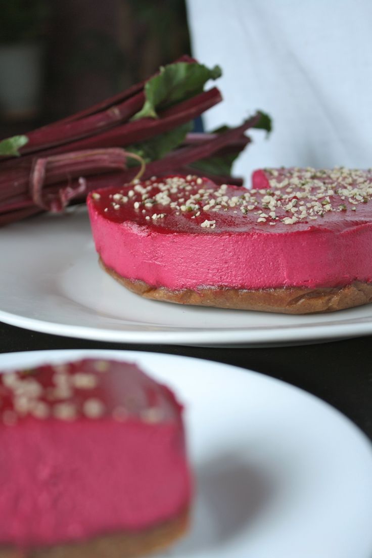 two white plates topped with cakes covered in pink frosting