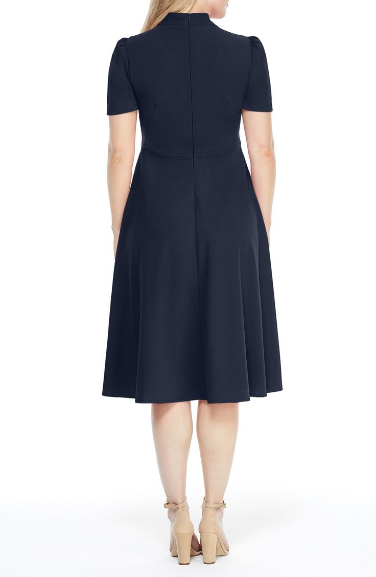 This dainty short sleeve dress is a retro inspired staple that's perfect for any well-dressed occasion. 45" length Necktie Short sleeves Back zip closure Lined 96% polyester, 4% spandex Hand wash, dry flat Imported Model Stats: 5'10" height; 34" bust; 27" waist; 35" hips. Spring Evening Knee-length Short Sleeve Dress, Fitted Midi Dress With Flattering Silhouette And Short Sleeves, Formal Short Sleeve Midi Dress With Flattering Silhouette, Formal Midi Dress With Flattering Silhouette And Short Sleeves, Short Sleeve Midi Dress With Flattering Silhouette For Evening, Evening Midi Dress With Flattering Silhouette And Short Sleeves, Midi Dress With Flattering Silhouette For Evening, Classic Fitted Dress With Cap Sleeves, Fitted Short Sleeve Midi Dress For Evening