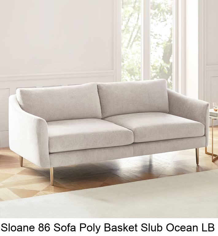 a white sofa sitting on top of a hard wood floor