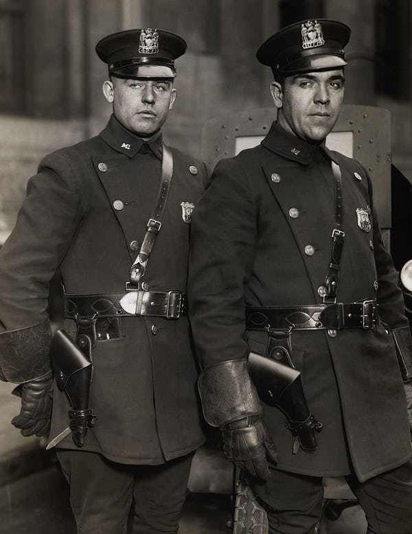 two men in uniform standing next to each other