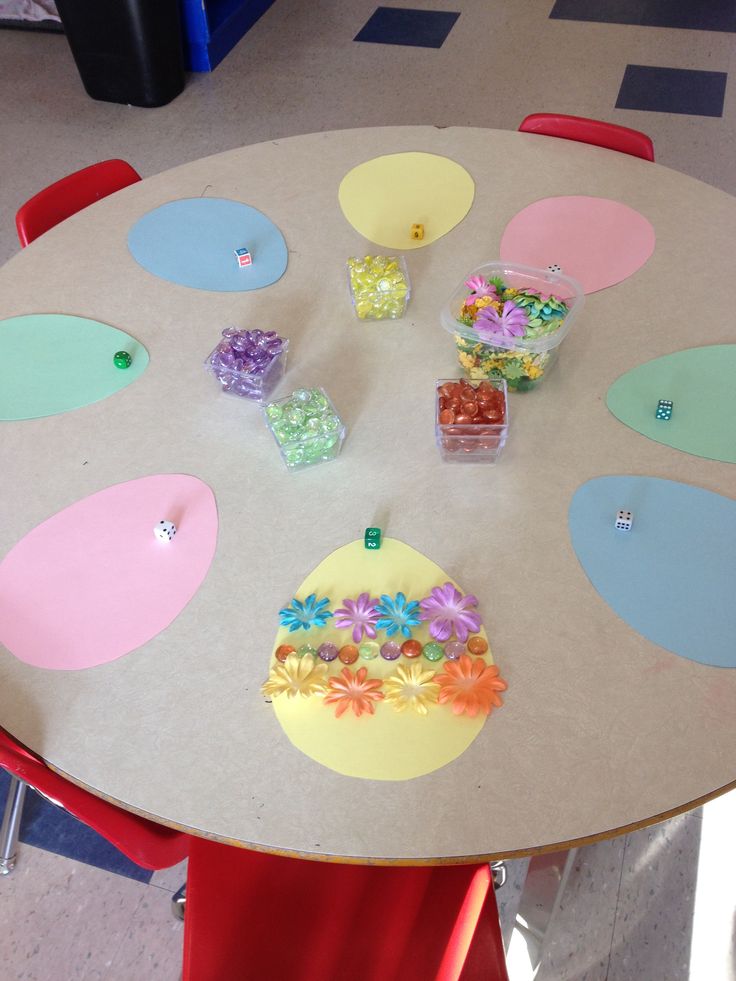 the table is decorated with colorful paper flowers and candies for easters or springtime treats