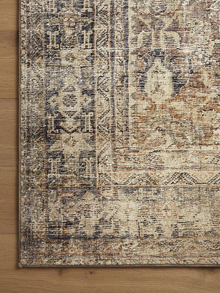 an area rug on a wooden floor with a wood flooring board in the background