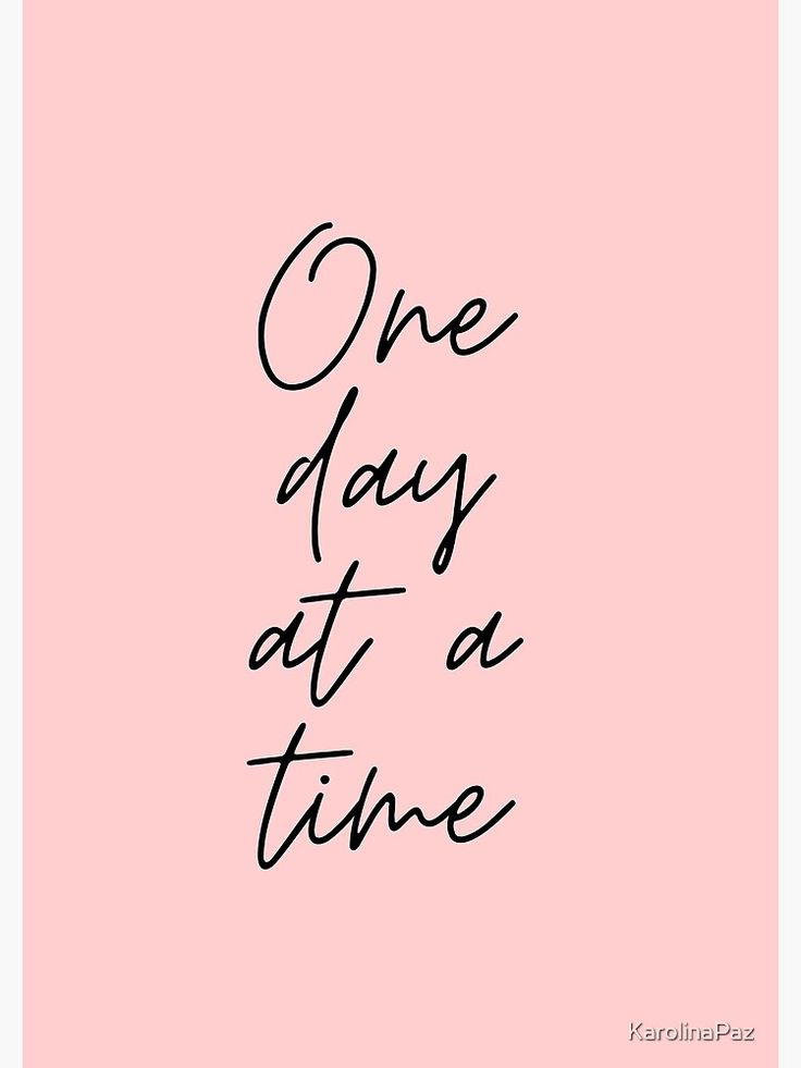 the words one day at a time written in black ink on a pink paper background