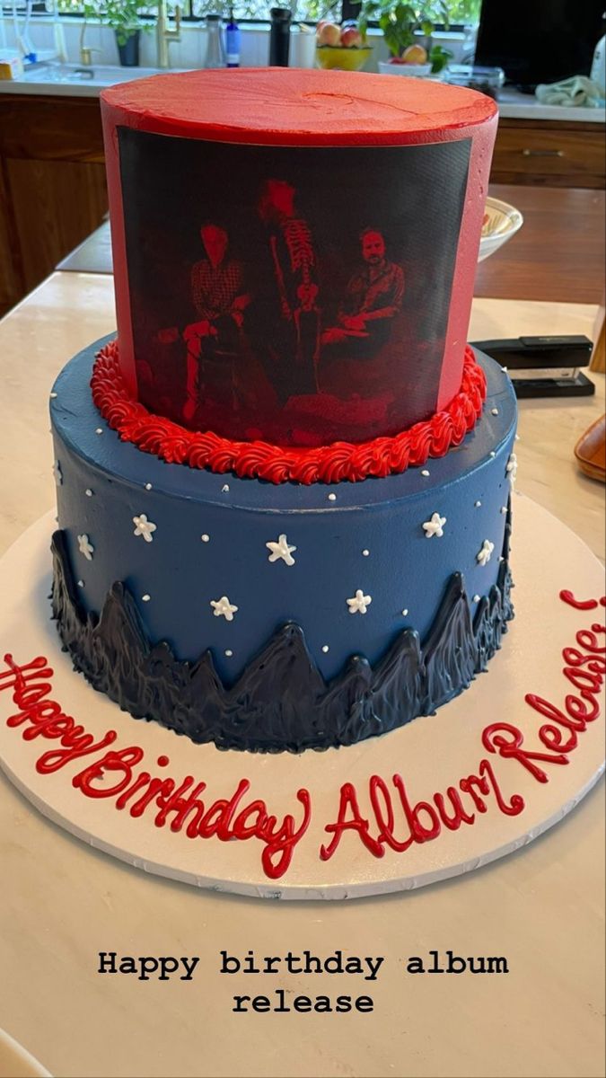 two tiered birthday cake with red, white and blue frosting