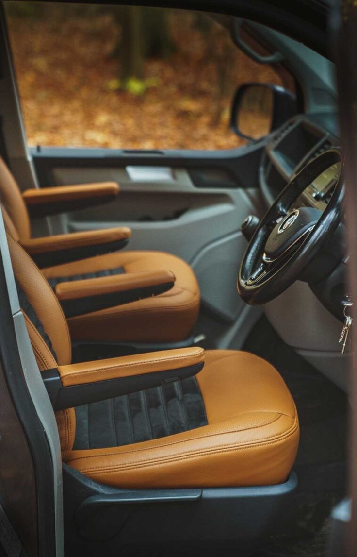 the interior of a vehicle with brown leather seats