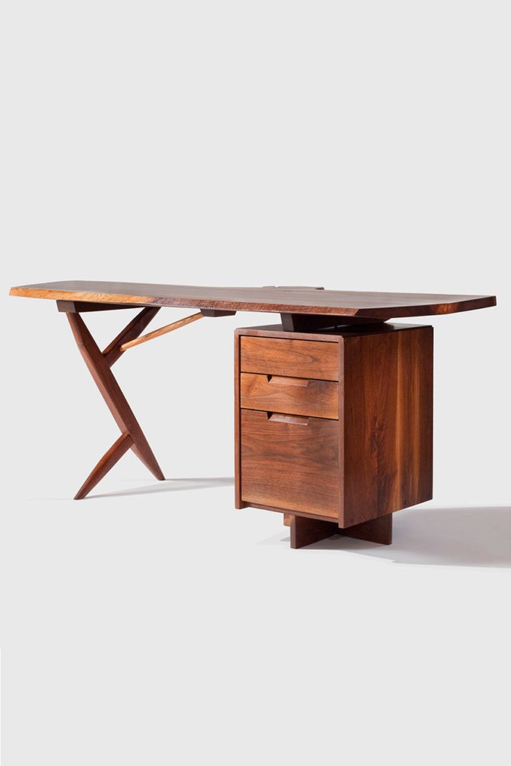 a wooden desk with two drawers and a cross - legged table on one end, against a white background