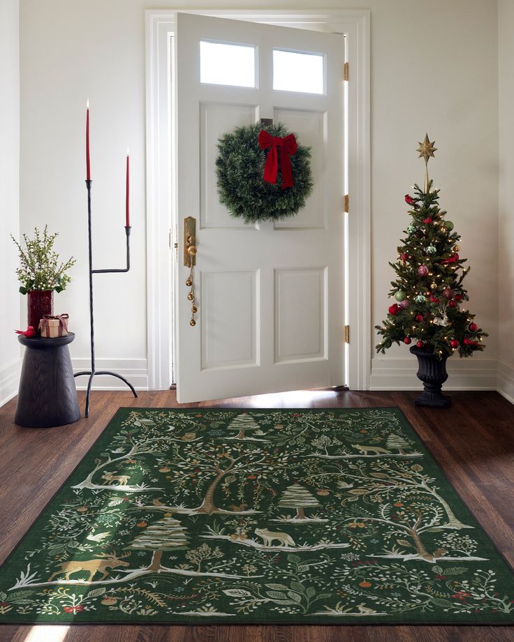 a green christmas rug in front of a white door