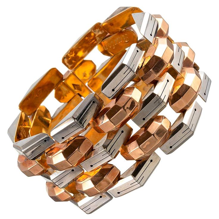 Faceted links of 18 karat rose gold are alternated with engraved links of 18 karat white gold, while the underside is finished in 18 karat yellow gold. This is a most uncommon means of creating such a bracelet and requires elevated skill. The resulting piece is as unusual as it is attractive, with a bold character and striking architecture that is expected from retro jewelry. It measures a hint under 7.75 inches long and 1.5 inches wide. Although the bracelet was made in the 1940s, the hand engr Hinge Bracelet, Gold Link Bracelet, Gold Link, Retro Jewelry, Hinged Bracelet, Yellow Gold Bracelet, Hand Engraving, Tri Color, Estate Jewelry