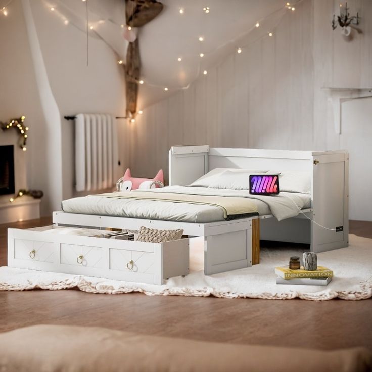 a white bed sitting on top of a hard wood floor next to a wooden dresser