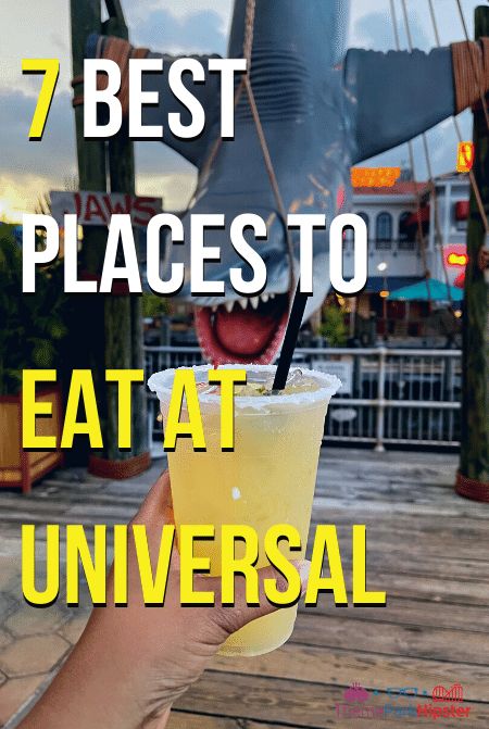 a person holding up a drink with the words 7 best places to eat at universal