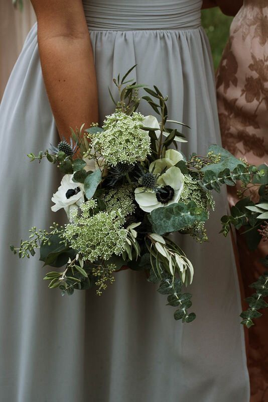 the bridesmaids are holding their bouquets with white and green flowers