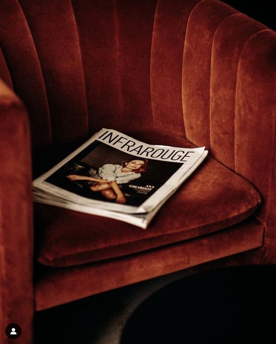 a magazine sitting on top of a red chair