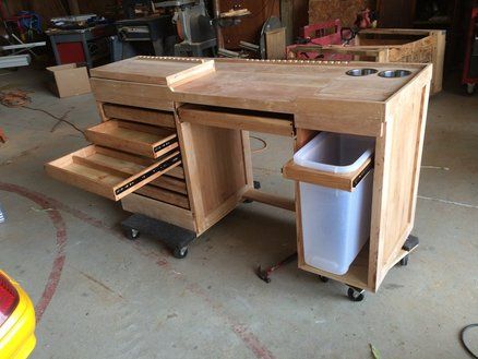 a workbench with drawers and a trash can