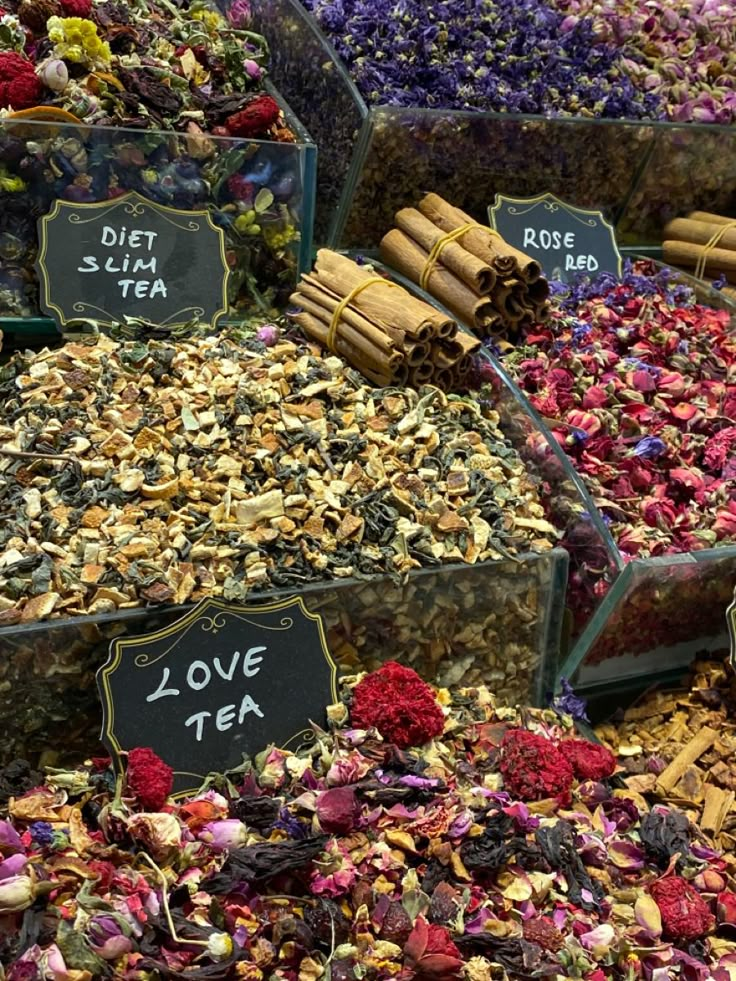 many different types of teas and flowers on display