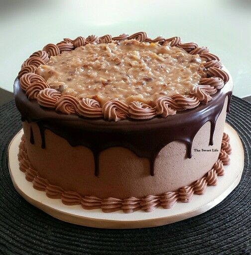 a cake with chocolate icing and peanut butter frosting sitting on top of a table