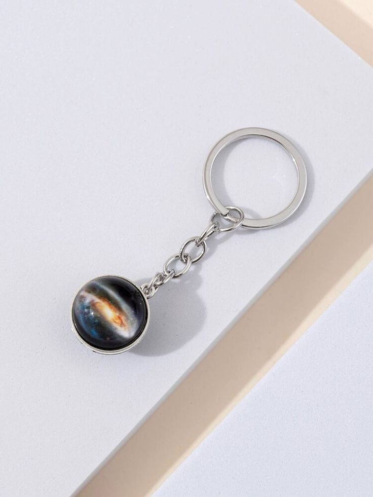 a keychain with an image of the solar system on it's side