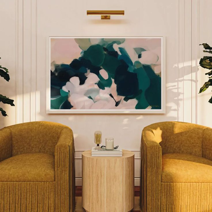 two yellow chairs sitting next to each other in front of a painting